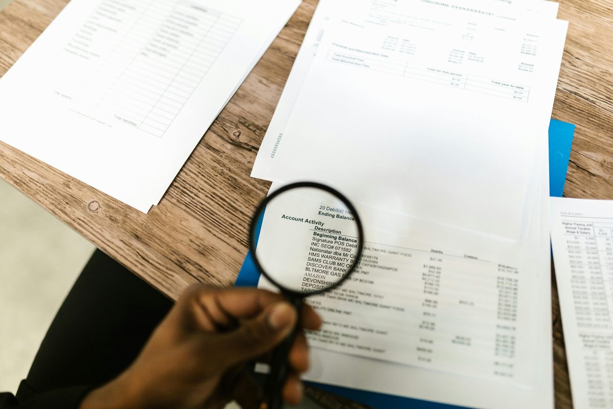 Reviewing Bison Cash loan documents with a magnifying glass — always read APR disclosures before signing